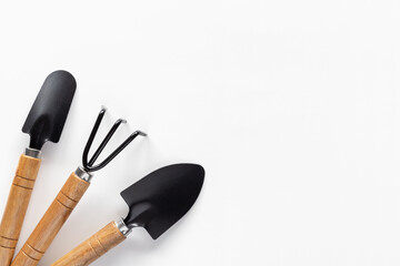 Gardening tools on white background. Small shovel, spatula and rake for planting