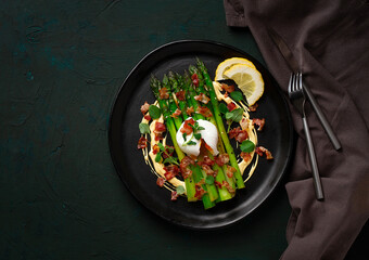 Green asparagus, with poached egg and bacon, hollandaise sauce, top view, horizontal, no people,