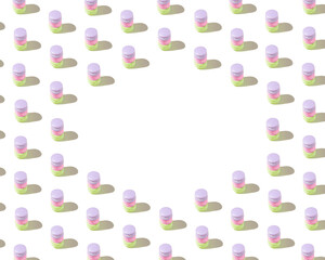 Pattern made of light pink, green, violet cakes, verticaly arranged whit shade on a white background and space for a message