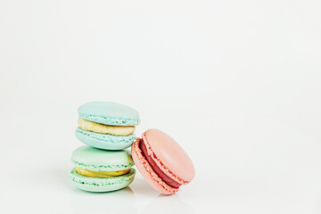 Sweet almond colorful pastel pink blue green macaron or macaroon dessert cake isolated on white background. French sweet cookie. Minimal food bakery concept Copy space