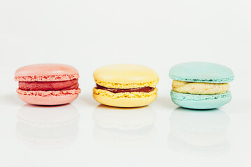 Sweet almond colorful pastel pink blue yellow macaron or macaroon dessert cake isolated on white background. French sweet cookie. Minimal food bakery concept Copy space