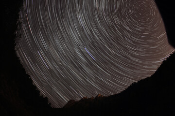 Night starry sky over the Siberian forest. Krasnoyarsk Nature Reserve Stolby, Takmak rock