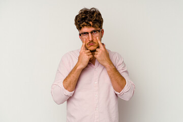 Young caucasian man isolated on white background crying, unhappy with something, agony and confusion concept.