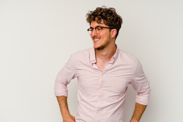 Young caucasian man isolated on white background laughs and closes eyes, feels relaxed and happy.