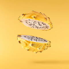 creative image with fresh yellow pitaya falling in the air, zero gravity food conception