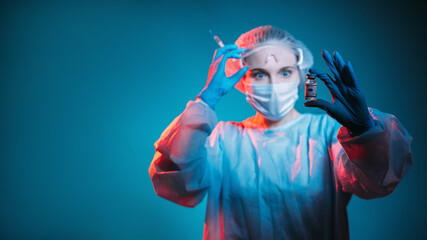 Vaccine development. Covid-19 immunization. Inoculation risk. Shocked female doctor in ppe goggles face mask gloves testing vial dose in hand in red neon light on dark blur blue copy space banner.