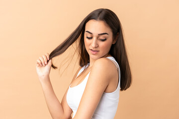 Naklejka premium Young caucasian woman isolated on beige background . Portrait