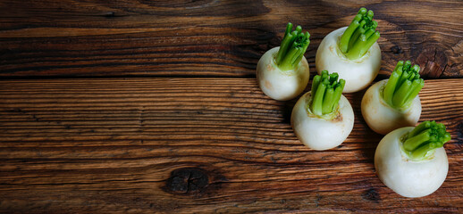 Radishes white  on wooden table. The concept of food. Copy the space for the text.