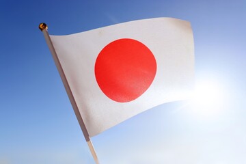 Flag of Japan against the sunny blue sky. Japanese flag background photo