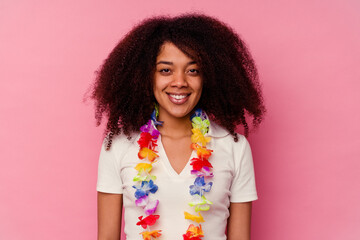 Young african american woman wearing a hawaiian stuff happy, smiling and cheerful.
