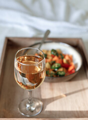Mixed Bell-pepper Salad with Lettuce egg wrap on a brown tray in room with plants and sunshine through the window