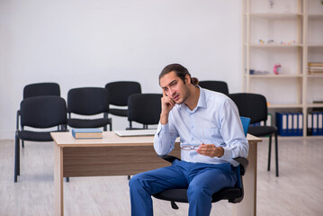 Young male boss giving seminar in the office during pandemic