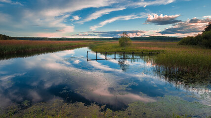A boat pier over a lake in a village at dawn in spring in the north. .Ladoga, Karelia, Russia