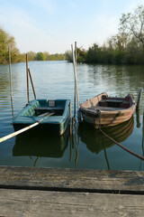 Obraz premium Abandoned rowing boat, isolated on a lake. Two wooden rowboat on water.