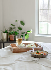 Mixed Bell-pepper Salad with Lettuce egg wrap on a brown tray in room with plants and sunshine through the window