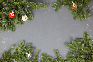 Christmas composition. Christmas decorations, fir branches on a gray background. Top view, flat styling, copy space.