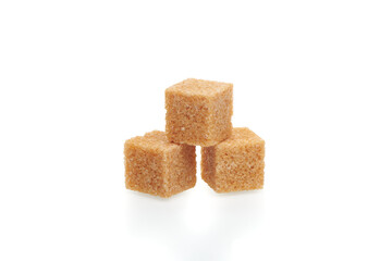 Three brown cubes of cane sugar isolated on white background. Close up view.