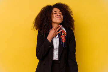 Young African American air hostess isolated on yellow background suffers pain in throat due a virus...
