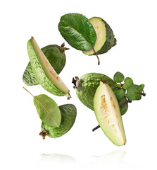 Fresh raw feijoa with green leaves falling in the air