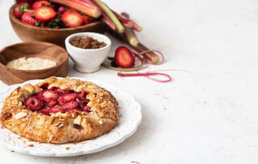 Baked galette with strawberry and rhubarb, pie on the table