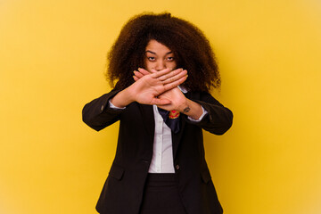 Young African American air hostess isolated on yellow background doing a denial gesture