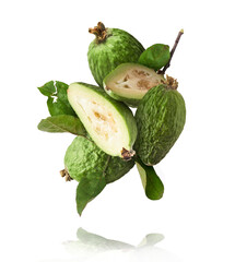 Fresh raw feijoa with green leaves falling in the air