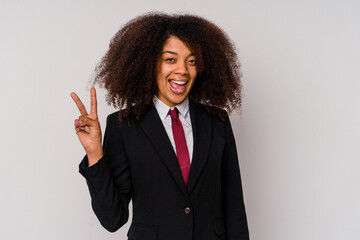Young African American business woman wearing a suit isolated on white background showing victory sign and smiling broadly.
