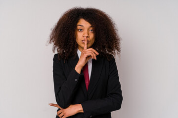 Fototapeta na wymiar Young African American business woman wearing a suit isolated on white background keeping a secret or asking for silence.