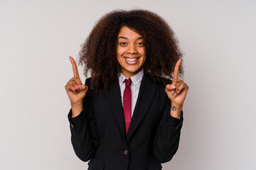 Young African American business woman wearing a suit isolated on white background indicates with both fore fingers up showing a blank space.