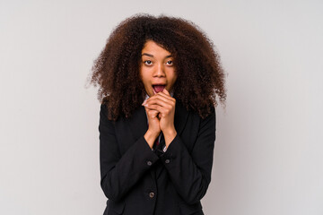 Fototapeta na wymiar Young African American business woman wearing a suit isolated on white background praying for luck, amazed and opening mouth looking to front.