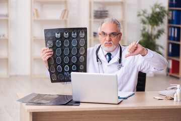 Experienced male doctor radiologist working in the clinic
