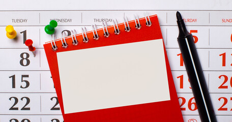 There is a red notepad and a black marker on the background of the calendar. On a notepad, there is a blank white card with a place to insert text. Template.