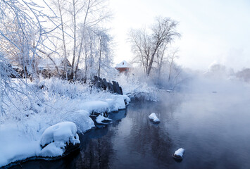 morning winter frosty landscape with fog and forest on river bank, Russia, Ural, January