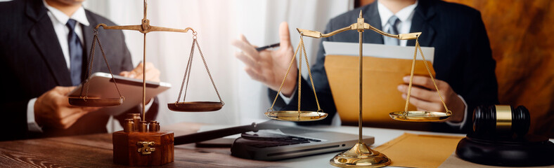 Justice and law concept.Male judge in a courtroom with the gavel, working with, computer and...
