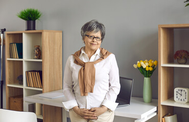 Professional career, elderly staff and business. Smiling senior female office worker, accountant,...