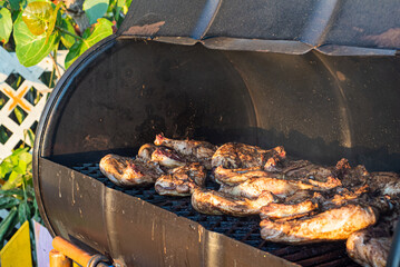 Jerk chicken cooked in a typical Caribbean style BBQ made from an old oil drum