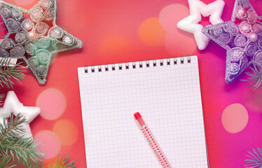 Christmas wish list, notepad on red background, to-do list, holiday mood with bokeh