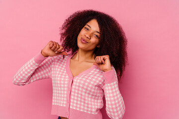 Young african american woman isolated on pink background feels proud and self confident, example to follow.