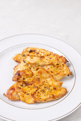 Delicious chicken breasts fried and served on the plate