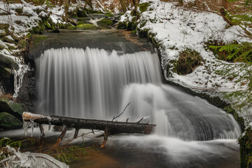 Waterfall on Jezerni creek in spring in national park Sumava in Czech republic