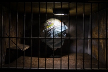 Fototapeta premium Prison or jail cell wall with window with bars, exterior perspective, COVID-19 corona virus disease pandemic outbreak, Coronavirus spreading among inmates, SARS-CoV-2 in correctional facility complex