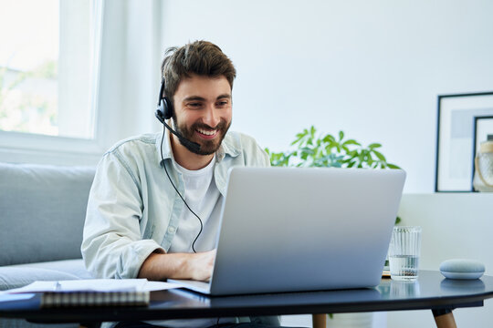 Young man with headset telecommuting
