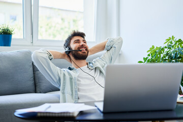 Successful young man working remotely from home office