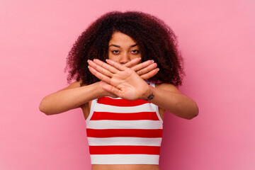 Young african american woman isolated on pink background doing a denial gesture