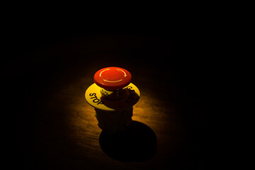 Emergency stop button, Disaster protection. Industrial concept. Red button on table in dark low key...