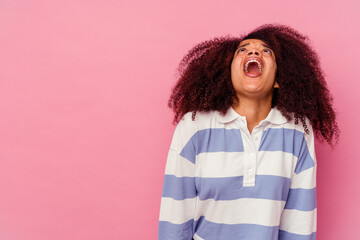 Young african american woman isolated on pink background shouting very angry, rage concept, frustrated.