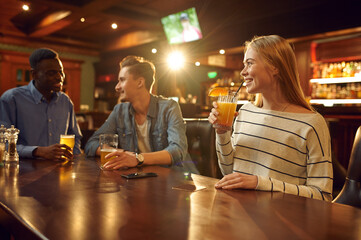 Friends with alcohol beverages having fun in bar