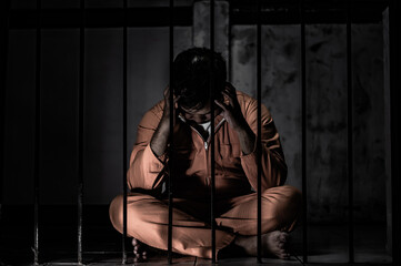 Asian man desperate at the iron prison,prisoner concept,thailand people,Hope to be free,Serious...