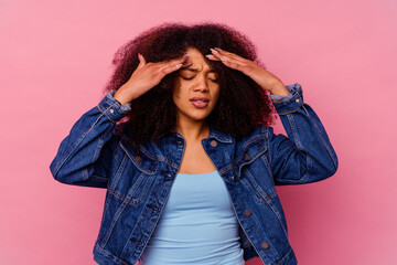 Young african american woman isolated on pink background having a head ache, touching front of the face.