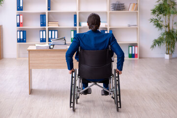 Young disabled employee working in the office